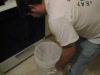 Putting the nylon mesh bag in the bucket.